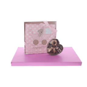 Pink blanket with heart-shaped box of dairy pralines